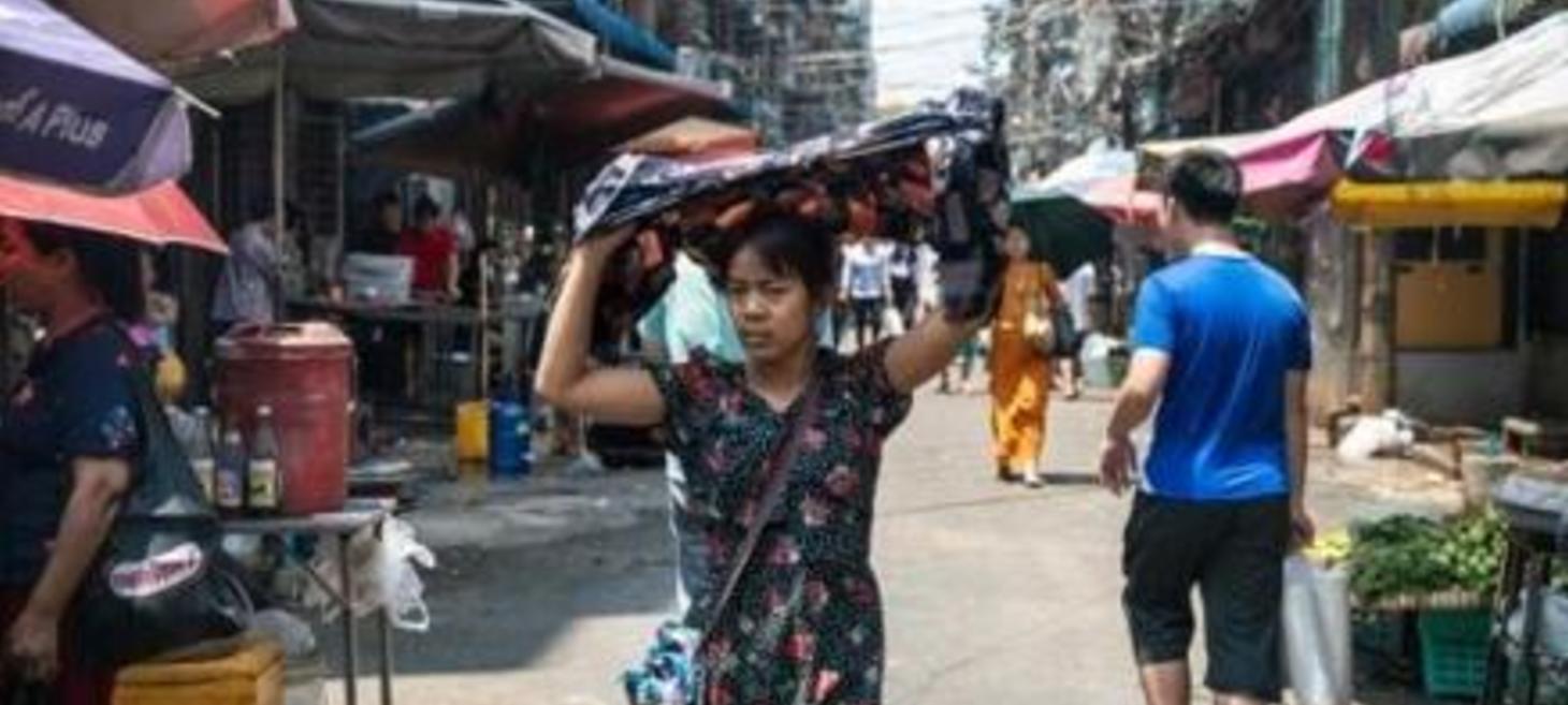 With motorbikes banned, Yangon delivery riders struggle in heatwave